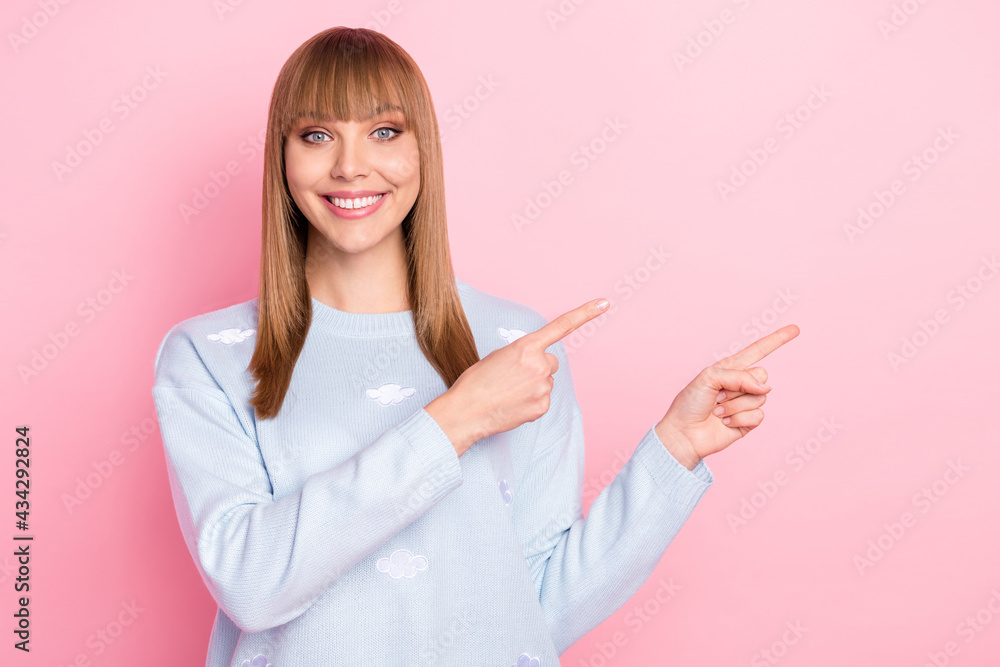 Portrait of attractive cheerful girl demonstrating ad copy empte place space isolated over pink pastel color background Portrait of attractive cheerful girl demonstrating ad copy empte place space isolated over pink pastel color background