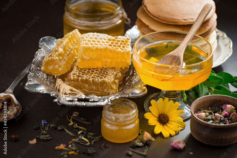 Sweet honey with flowers on an old background. Sweet honey with flowers on an old background.