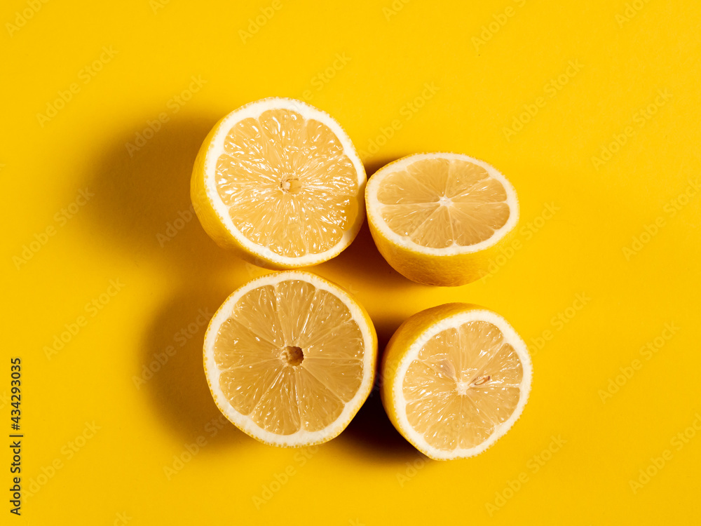 Yellow juicy lemon on a bright solid background. The citrus is in the middle. Horizontal orientation Yellow juicy lemon on a bright solid background. The citrus is in the middle. Horizontal orientation