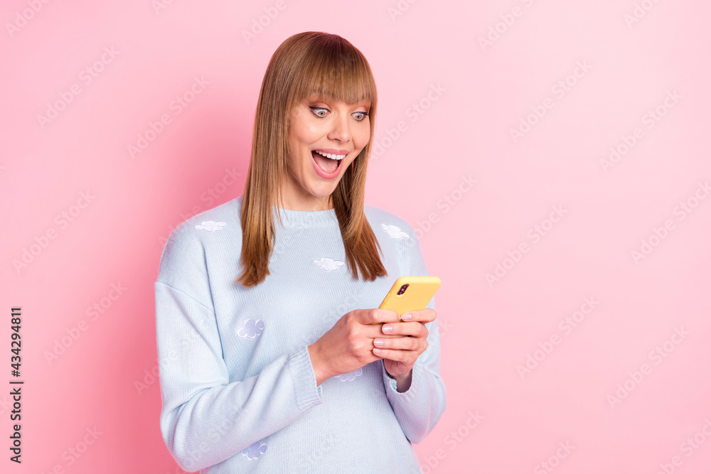 Portrait of attractive cheerful focused girl using device browsing having fun like isolated over pink pastel color background Portrait of attractive cheerful focused girl using device browsing having fun like isolated over pink pastel color background