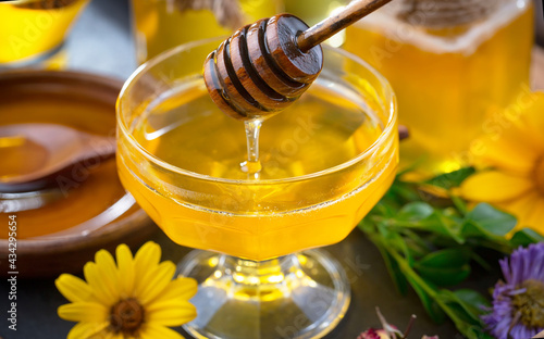 Sweet honey with flowers on an old background.