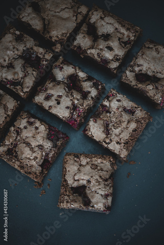 Tasty vegetarian brownie made from chocolate and cacao. Delicious chocolate pie. Selective focus. Flat lay composition with fresh brownies on dark background. Homemade dessert. No sugar pastry