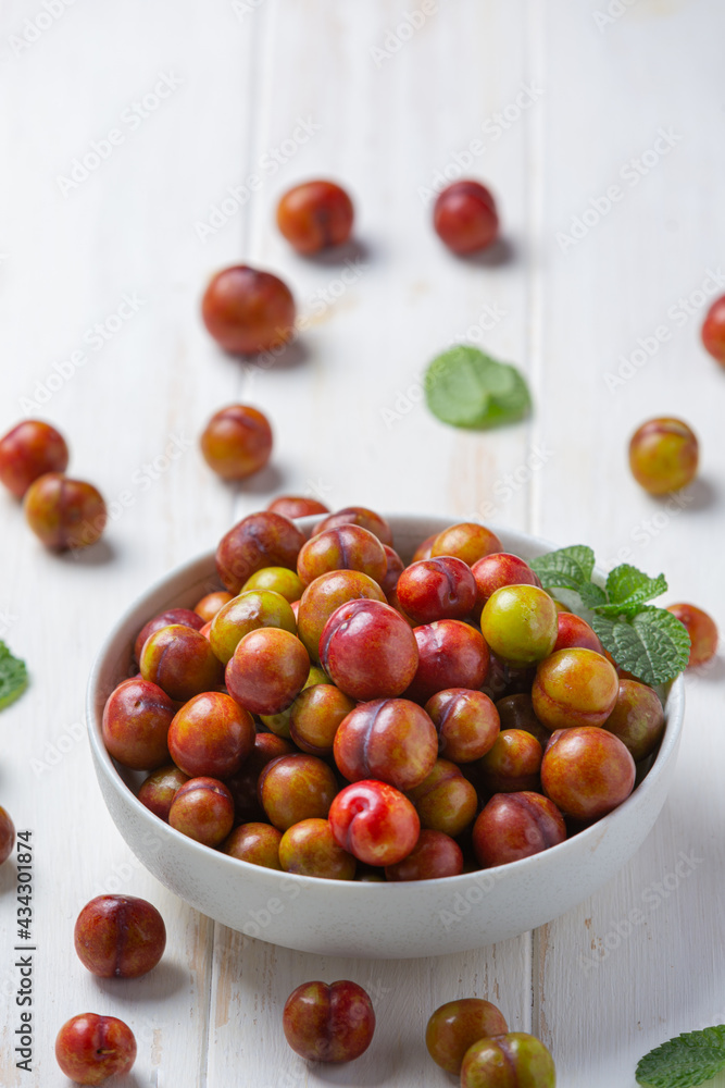 Ripe plums on the white wooden background. Ripe plums on the white wooden background.