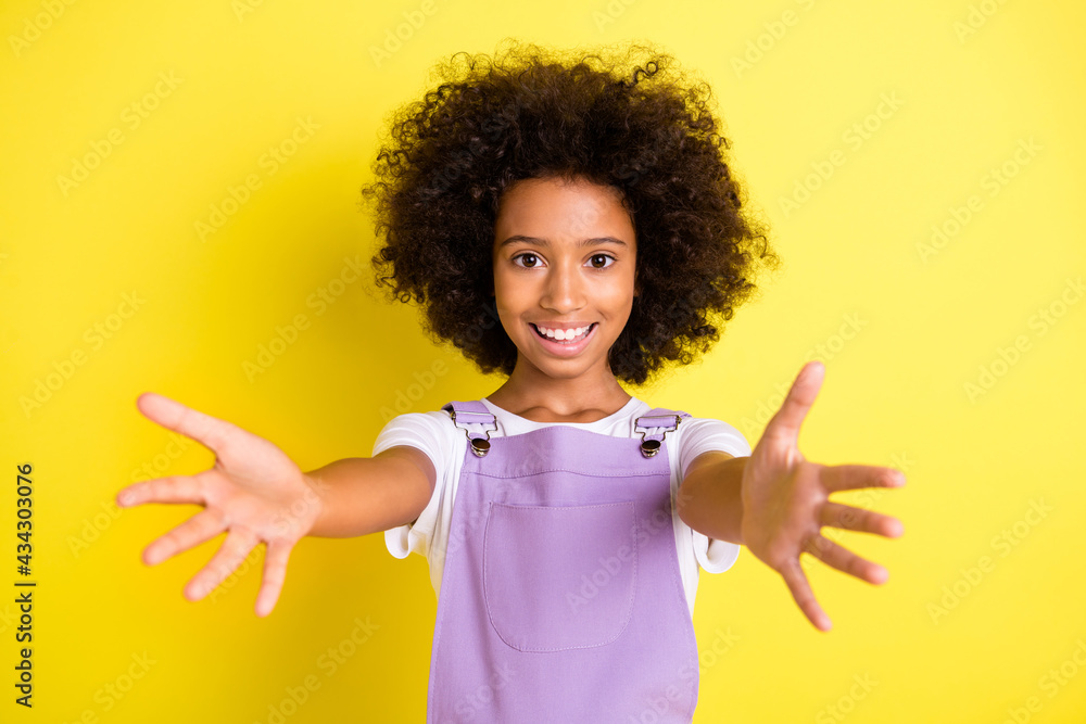 Portrait of pretty kind careful cheerful wavy-haired girl hugging you isolated over bright yellow color background Portrait of pretty kind careful cheerful wavy-haired girl hugging you isolated over bright yellow color background