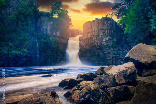 High Force Waterfall views from the south bank of the River Tees on the Pennine Way at sunset in woodland, UK. photo