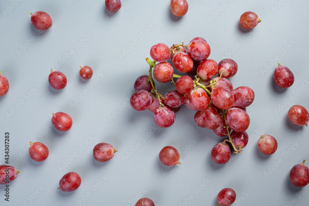 Bunches of fresh ripe red grapes on blue background. Bunches of fresh ripe red grapes on blue background.