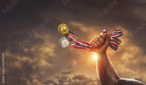 different medals in hand - dynamic Victory Concept