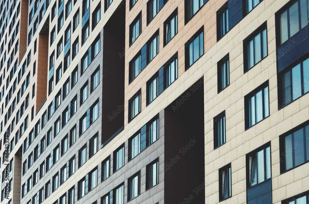 Facade of a modern building.Background with rows of glass windows.