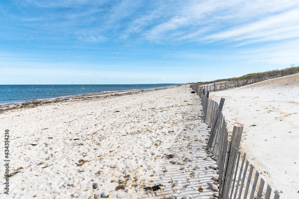 Deserted sandy beach and blue ocean on a sunny autumn day. Cape Cod, MA, USA,