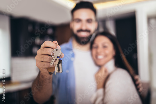 Couple showing keys to new home