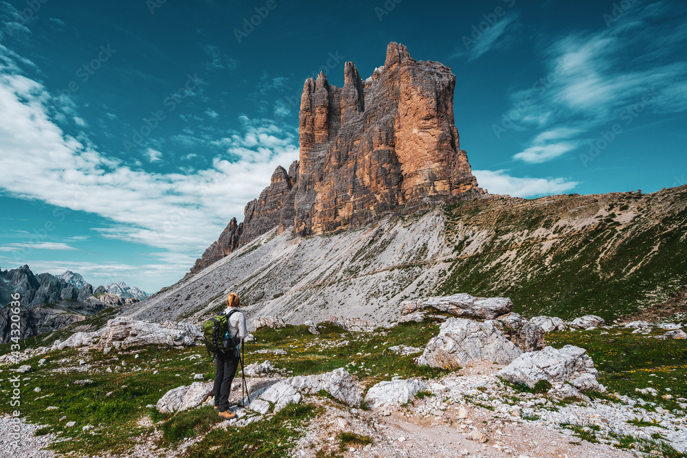 Backpacker on hiking trails in the Dolomites, Italy..View of the Three Peaks.
