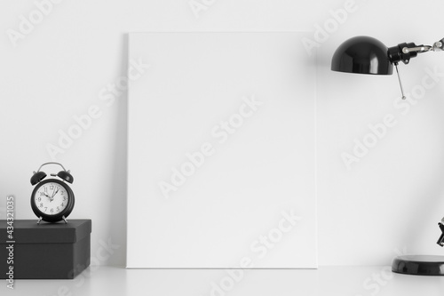 White canvas mockup with workspace accessories on the desk.