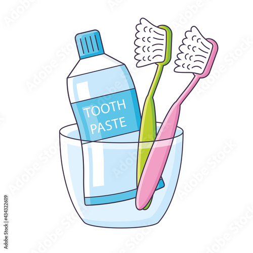 Toothbrushes and toothpaste in a cup isolated