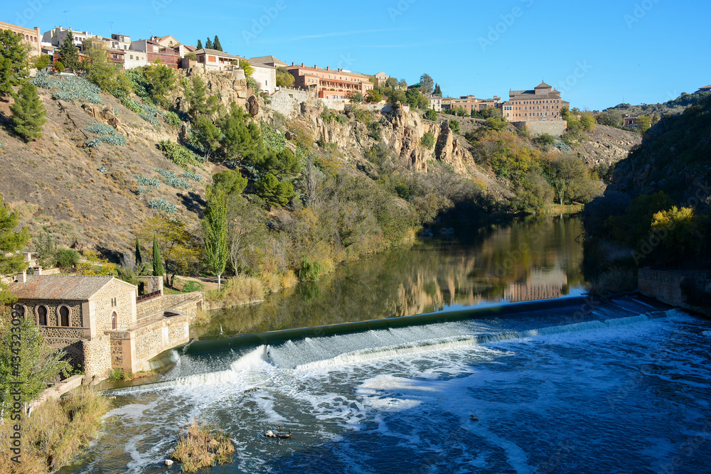 Toledo, Spain - October 29, 2020: View to the Tagus river with ancient mill dam