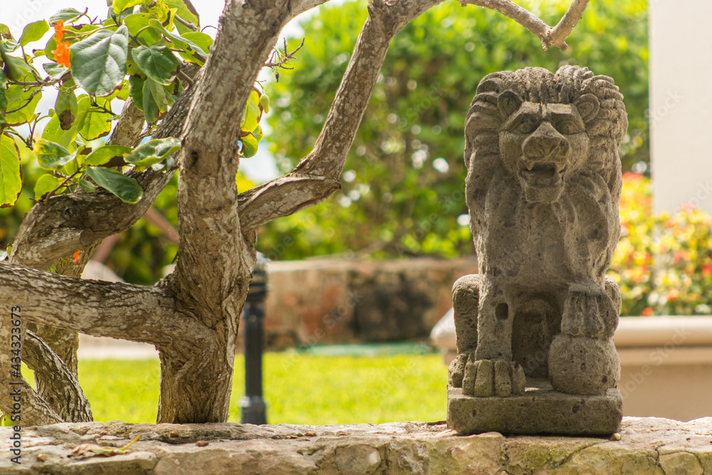 Lion statue over stone wall