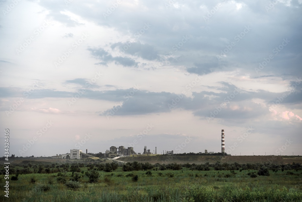 old plant factory in distance. landscape with industrial building and pipe