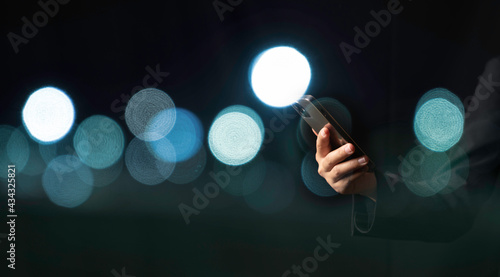 Business woman hand using smartphone with bokeh background. People lifestyle, mobile phone technology, city life, online shopping concept.