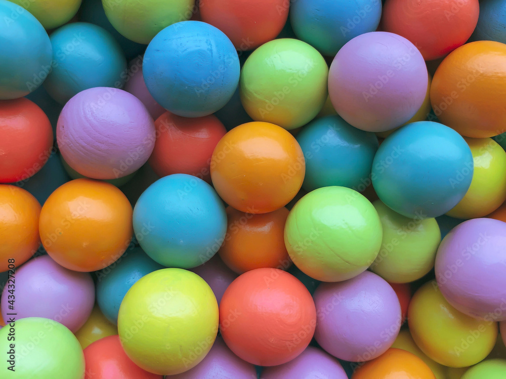 Background from multicolored bright small wooden balls of blue, yellow, red, lilac and green colors. A beautiful summer bright background for your projects.. Background from multicolored bright small wooden balls of blue, yellow, red, lilac and green colors. A beautiful summer bright background for your projects..
