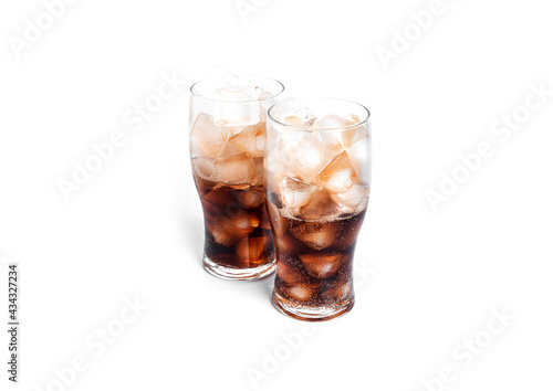 Soda with ice in a transparent glasses isolated on a white background.