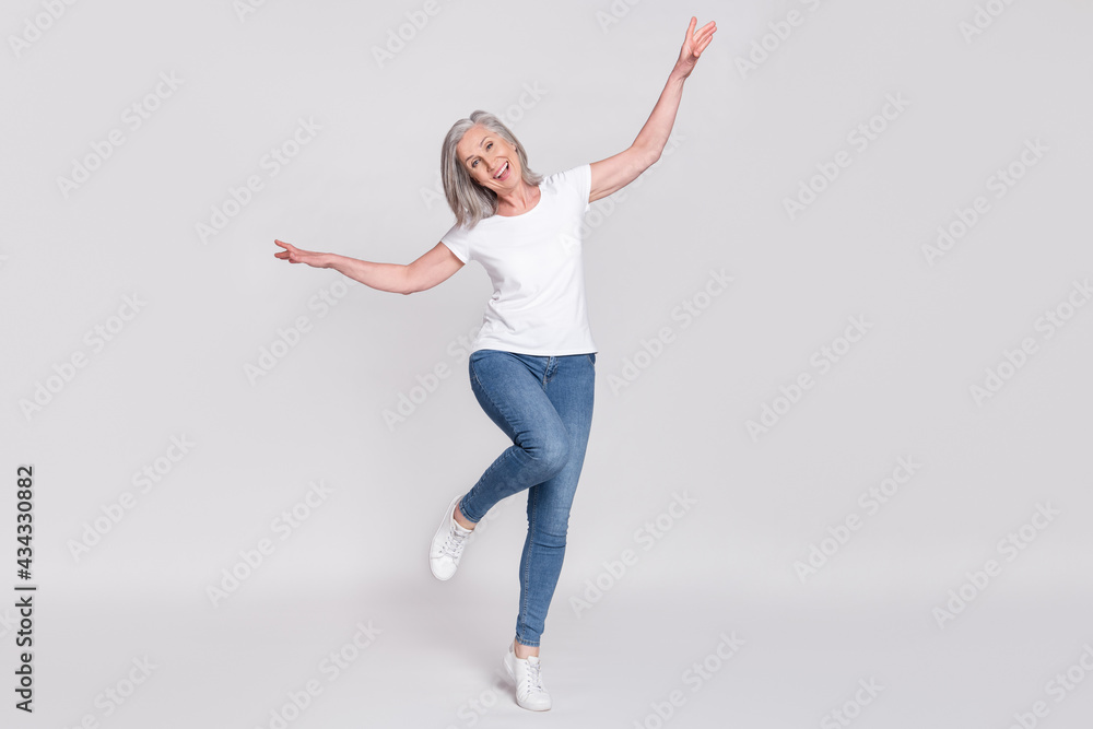 Full body photo of cheerful aged woman happy positive smile have fun isolated over grey color background