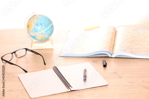 In the office there is a globe and a map of the world on the table for choosing a market for products.