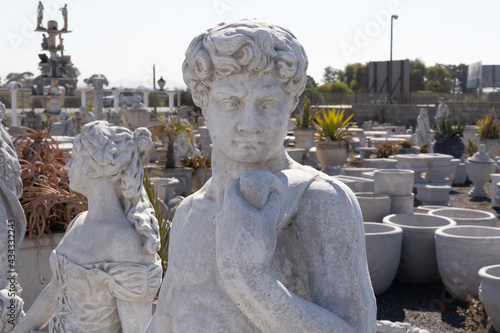 Tablou pe pânză Ancient stone sculpture of man in reclamation yard
