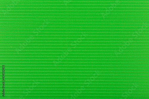 Green wall texture with horizontal stripes. Green paper background. Flay, copy space. 