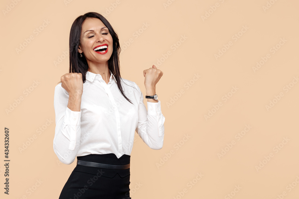 Happy young modern business woman over beige background. Success and winner concept. Closed eyes. Happy young modern business woman over beige background. Success and winner concept. Closed eyes.