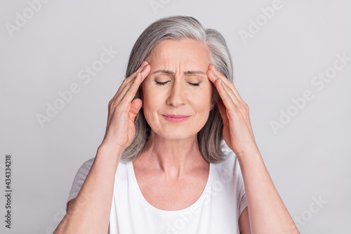 Photo of senior woman hands touch head ache pain suffer ill migraine sick isolated over grey color background