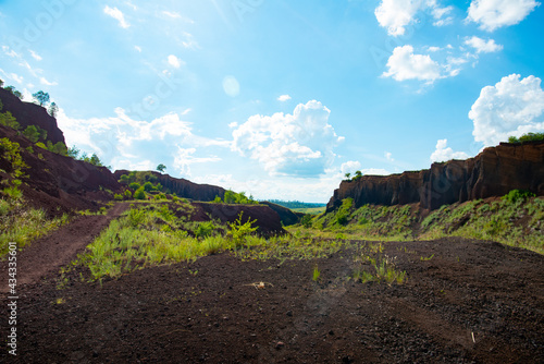 limestone cliffs from the old volcano and green vegetation in the middle of the plain