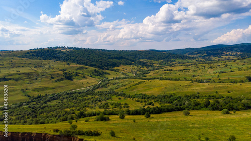 limestone cliffs from the old volcano and green vegetation in the middle of the plain