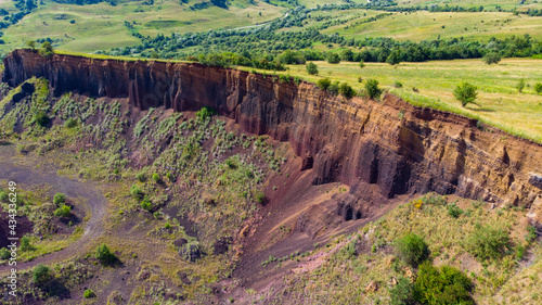 limestone cliffs from the old volcano and green vegetation in the middle of the plain