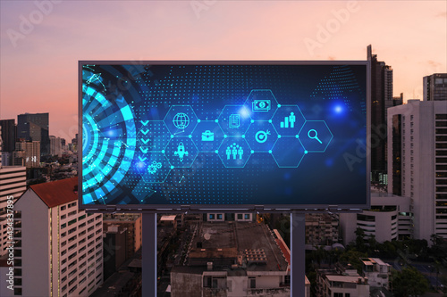 Research and technological development glowing icons on billboard. Night panoramic city view of Bangkok. Concept of innovative activities expanding new services or products in Southeast Asia.