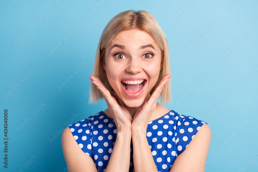 Photo of young cheerful girl happy positive smile amazed shocked excited isolated over blue color background Photo of young cheerful girl happy positive smile amazed shocked excited isolated over blue color background