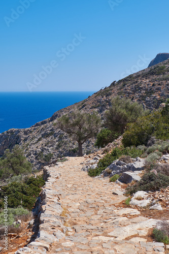 Stone walkway, pathway at the cliffs of the Mediterranean sea in Crete, near Pahos, in Greece photo