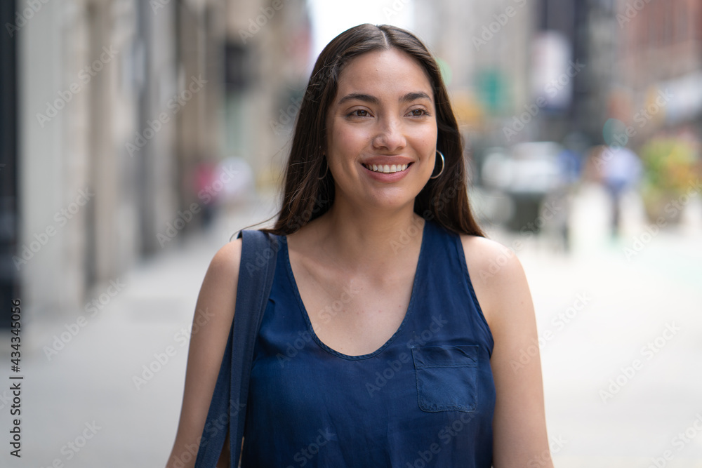 Young Latina Hispanic woman walking street smiling happy face