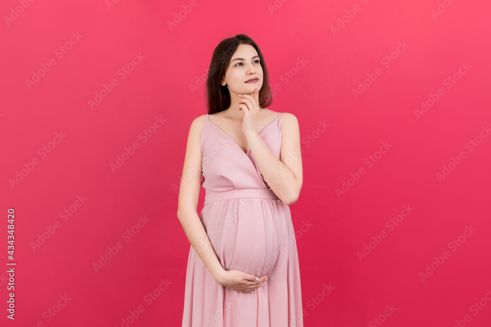Pensive pregnant woman choosing name for baby on colored background. Dream and Happy Pregnant Woman Thinking Imagining Motherhood Life. Copy Space
