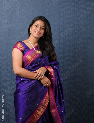 Smiling Attractive Indian Woman in saree Showing Copyspace or presenting