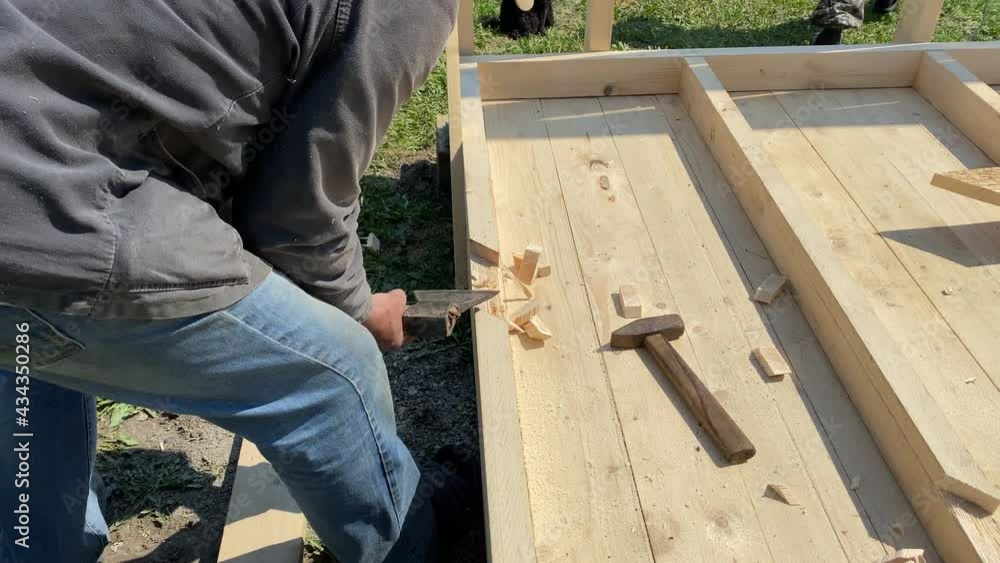 A man builds the frame of a gazebo. A man builds the frame of a gazebo.