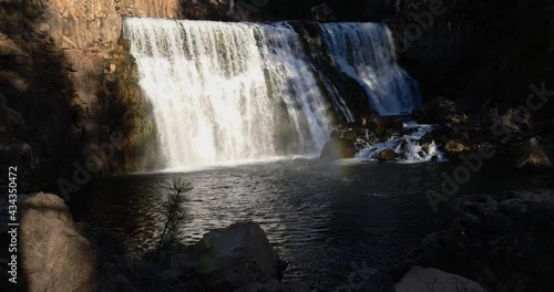 A beautiful view of the Mccloud waterfalls in the forest captured in California photo