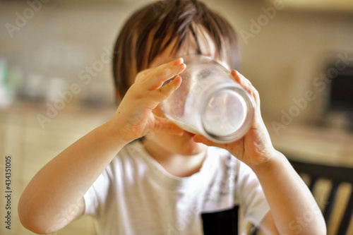 a little boy drinks milk