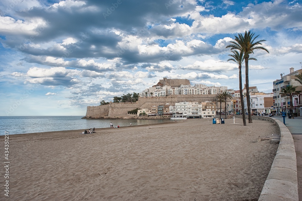 Panoramic Castle of Peñíscola with blue sky with broken clouds in spring on the seashore