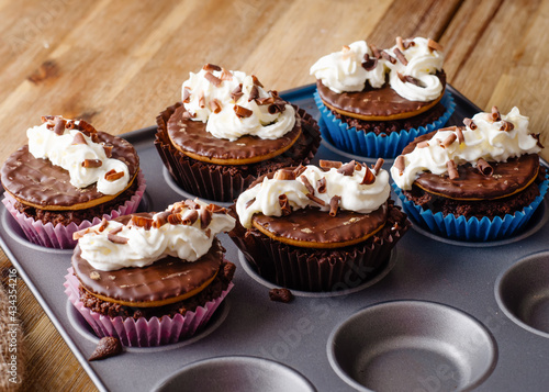 homemade chocolate cupcakes in cupcake mold on the table in the kitchen