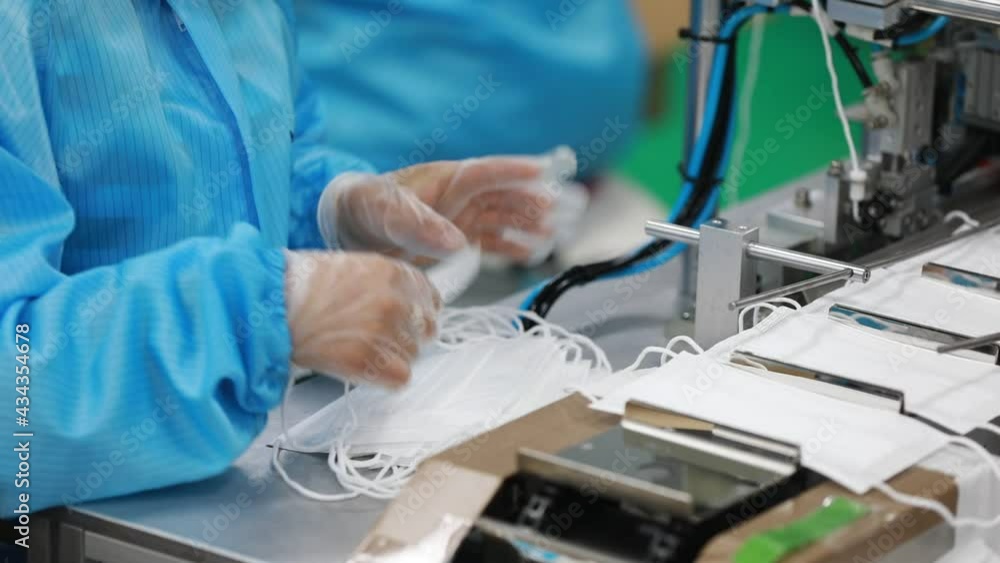 workers work hard on a medical mask production line workers work hard on a medical mask production line
