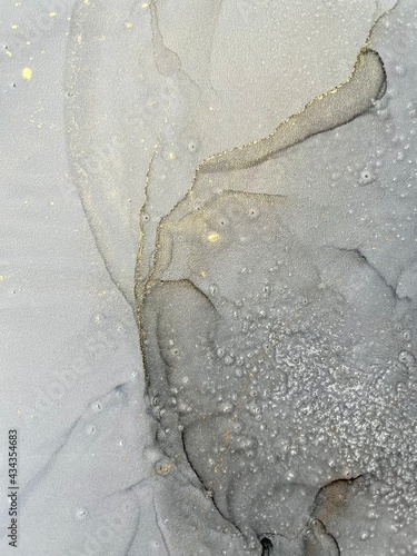 Alcohol ink abstract drawing grey and gold background 