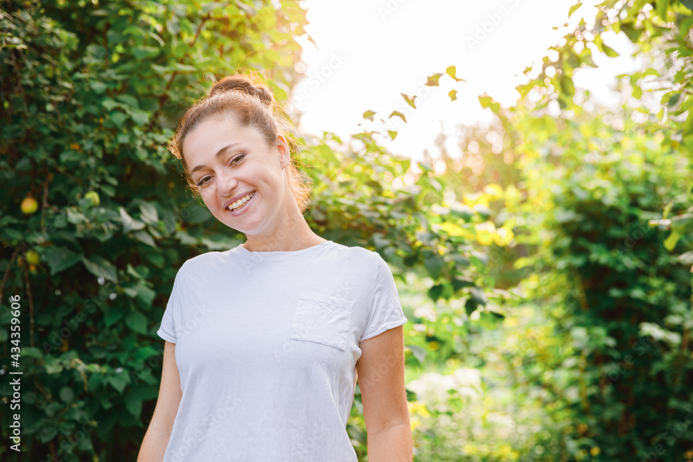 Young woman smiling outdoor. Beautiful brunete girl resting on park or garden green background. Free happy woman at summertime. Freedom happiness carefree happy people concept. Young woman smiling outdoor. Beautiful brunete girl resting on park or garden green background. Free happy woman at summertime. Freedom happiness carefree happy people concept.