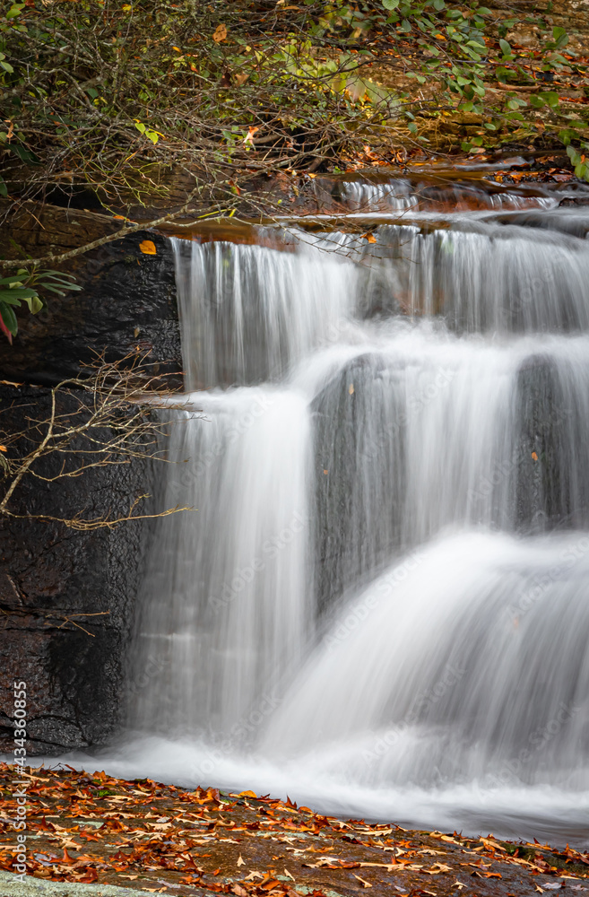 Stairstep falls surrounded by colorful fall leaves in Pisgah Forest Stairstep falls surrounded by colorful fall leaves in Pisgah Forest