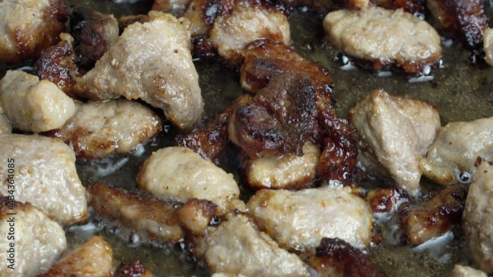 4K video clip of frying pieces of meat in a frying pan with oil at high temperature close-up. We cook roast pork at home. The process of cooking dinner food, the recipe for cooking fried meat. 4K video clip of frying pieces of meat in a frying pan with oil at high temperature close-up. We cook roast pork at home. The process of cooking dinner food, the recipe for cooking fried meat.