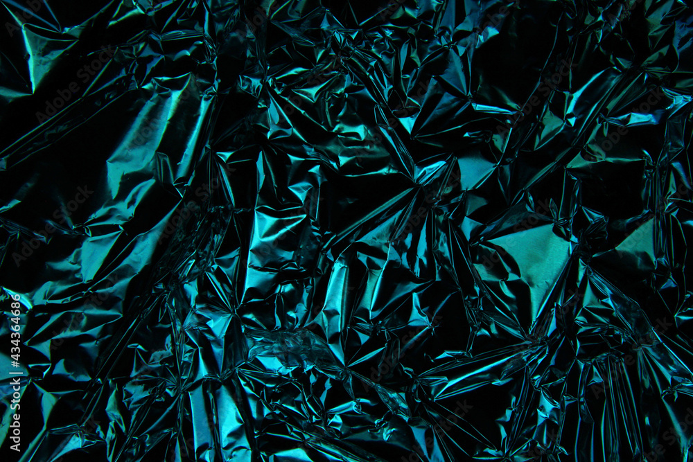 Foil background. Crumpled foil. Abstract background. Wallpaper. Blue