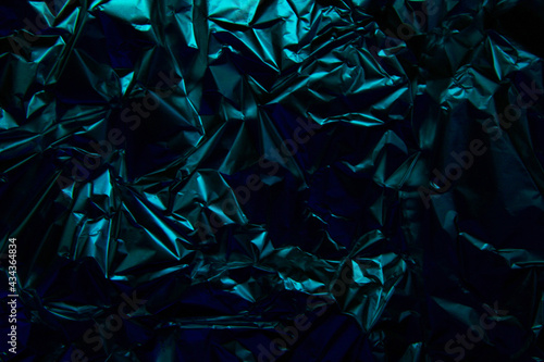 Foil background. Crumpled foil. Abstract background. Wallpaper. Blue and black